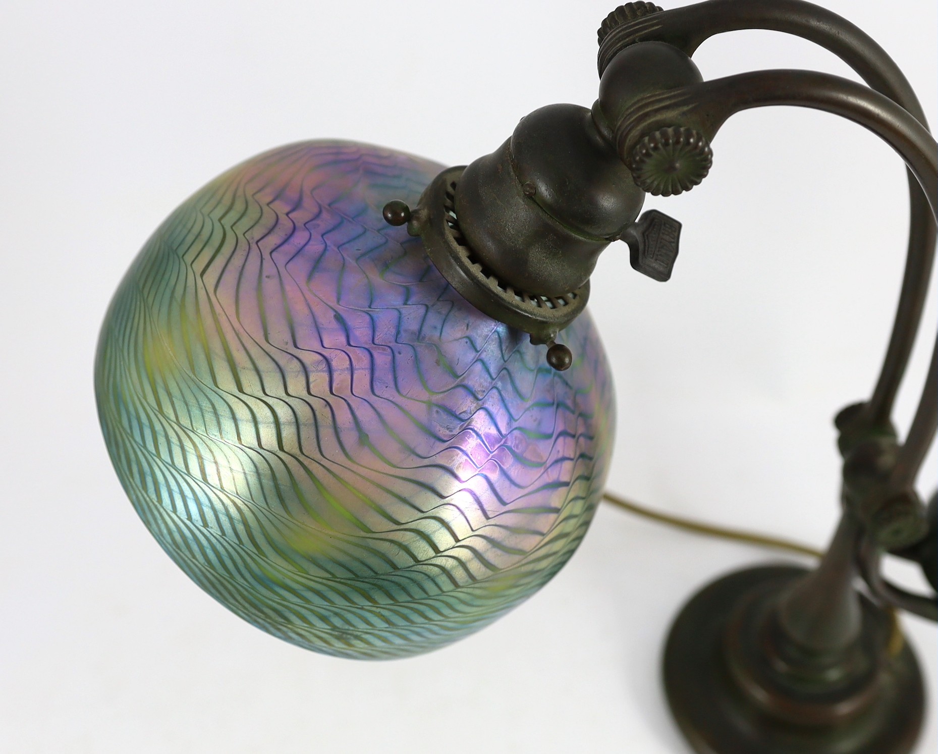 Tiffany Studios, a counter-balance patinated bronze desk lamp with ‘favrile’ glass shade, c.1905, maximum height 41cm, shade 17.3cm diameter